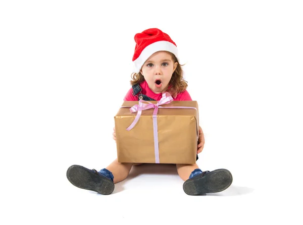 Surprised blonde christmas kid with present — Stock Photo, Image