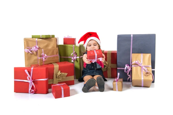 Blonde christmas kid around several presents — Stock Photo, Image