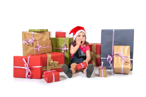 Blonde christmas kid around several presents doing surprise gesture — Stock Photo, Image