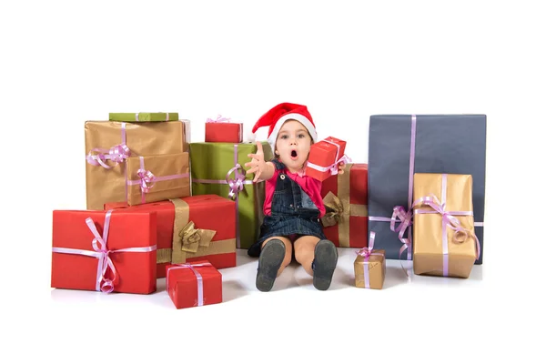 Blonde christmas kid around several presents doing surprise gesture — Stock Photo, Image