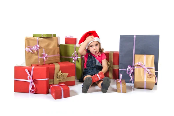 Blonde christmas kid around several presents doing surprise gesture — Stock Photo, Image