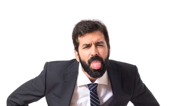 Businessman doing a joke over isolated white background — Stock Photo, Image