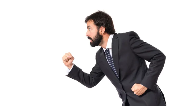 Businessman running fast over white background — Stock Photo, Image