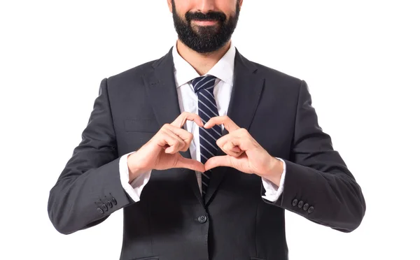 Empresario haciendo un corazón con sus manos sobre fondo blanco —  Fotos de Stock