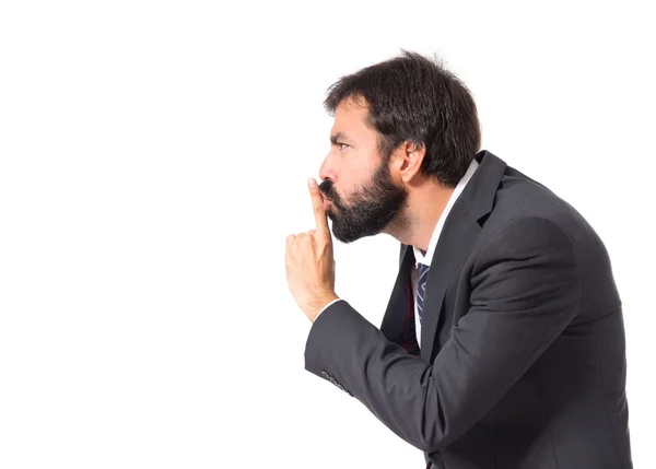 Geschäftsmann macht Schweigegeste über isolierten weißen Hintergrund — Stockfoto