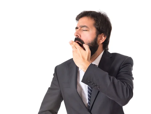 Empresario bostezando sobre fondo blanco aislado —  Fotos de Stock