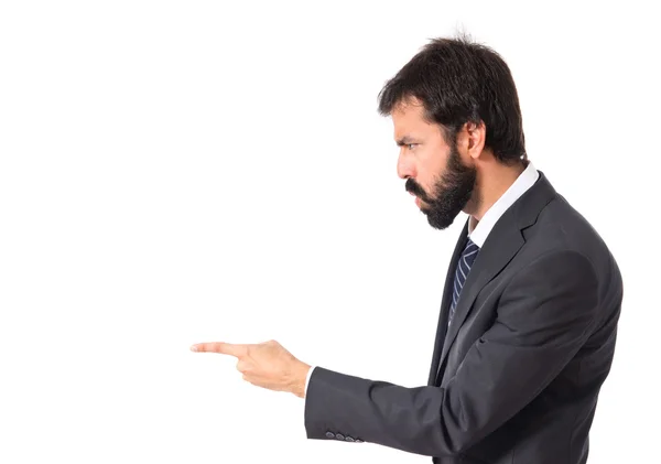 Businessman pointing and shouting over isolated white background — Stock Photo, Image