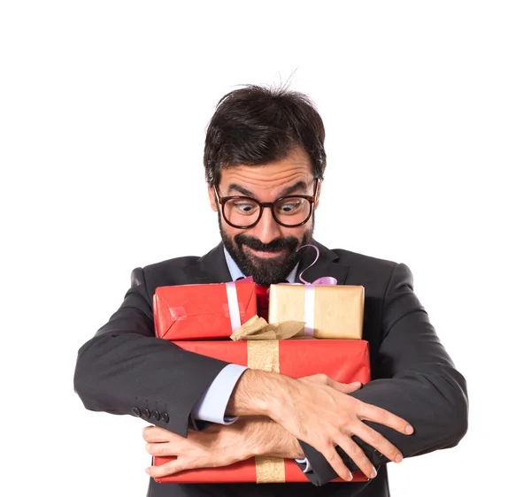 Businessman with several gifts — Stock Photo, Image