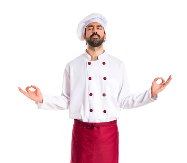 Шеф-повар в позе дзен на белом фоне — стоковое фото