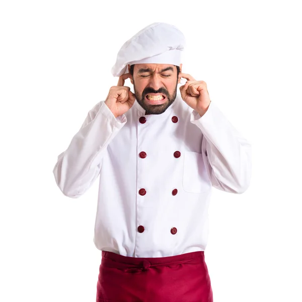 Chef covering his ears over white background — Stock Photo, Image