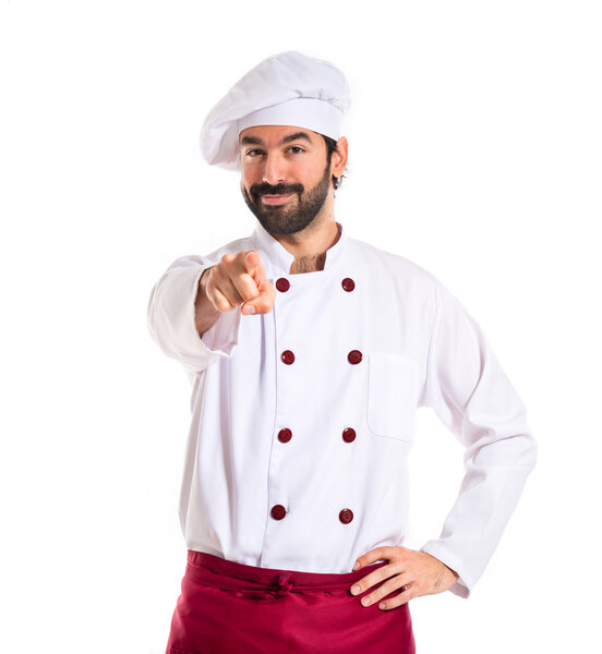 Chef pointing to the front over white background