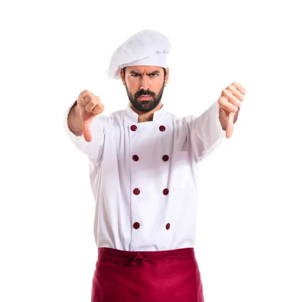 Chef doing a bad signal over white background — Stock Photo, Image