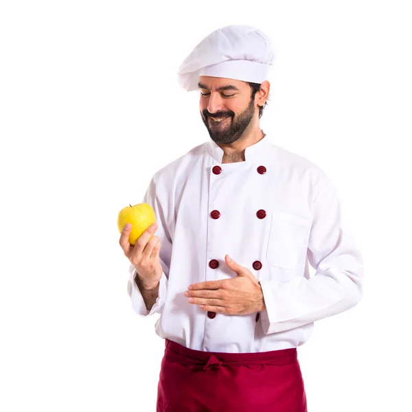 Küchenchef hält einen Apfel in der Hand — Stockfoto