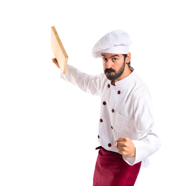 Шеф-повар атакует кухонным инструментом — стоковое фото