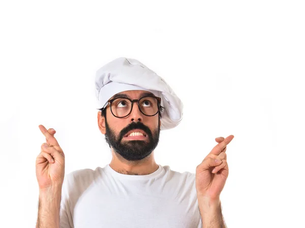 Chef-kok met zijn vingers oversteken witte achtergrond — Stockfoto