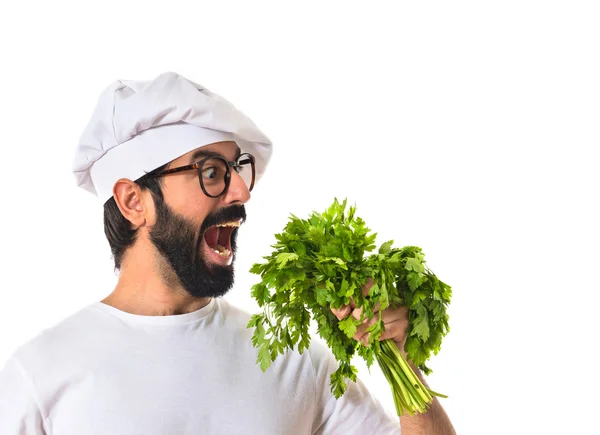 Chef holding lettuce over white background — Stock Photo, Image