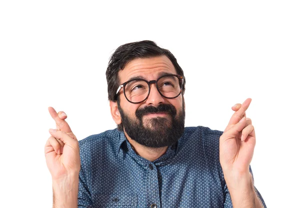 Young hipster man with his fingers crossing — Stock Photo, Image