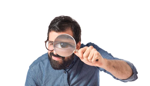 Young hipster man with magnifying glass — Stock Photo, Image