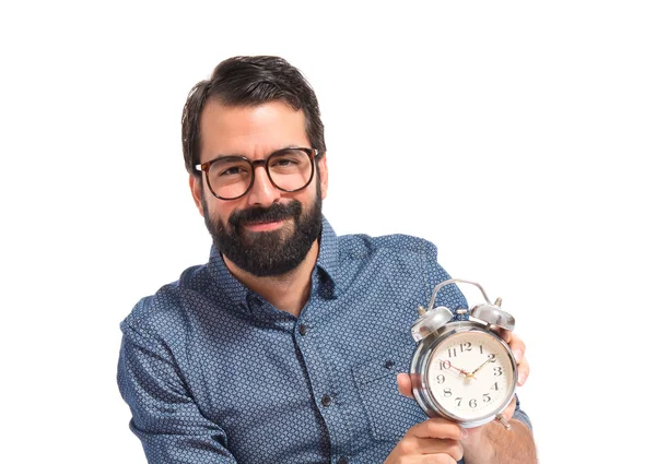 Young hipster man holding a clock — Stock Photo, Image