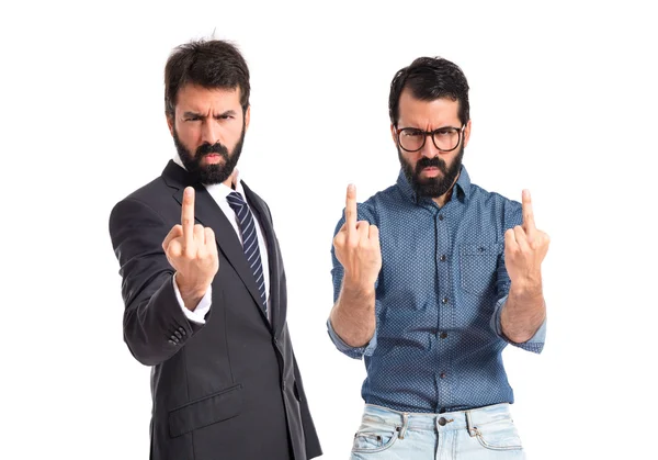 Twin brothers making horn gesture over white background — Stock Photo, Image