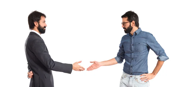 Brothers making a deal over white background — Stock Photo, Image