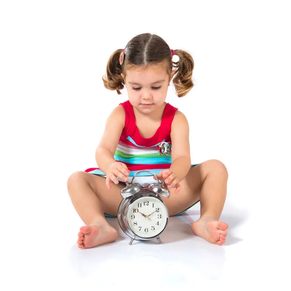 Kid holding a clock over white background Royalty Free Stock Images