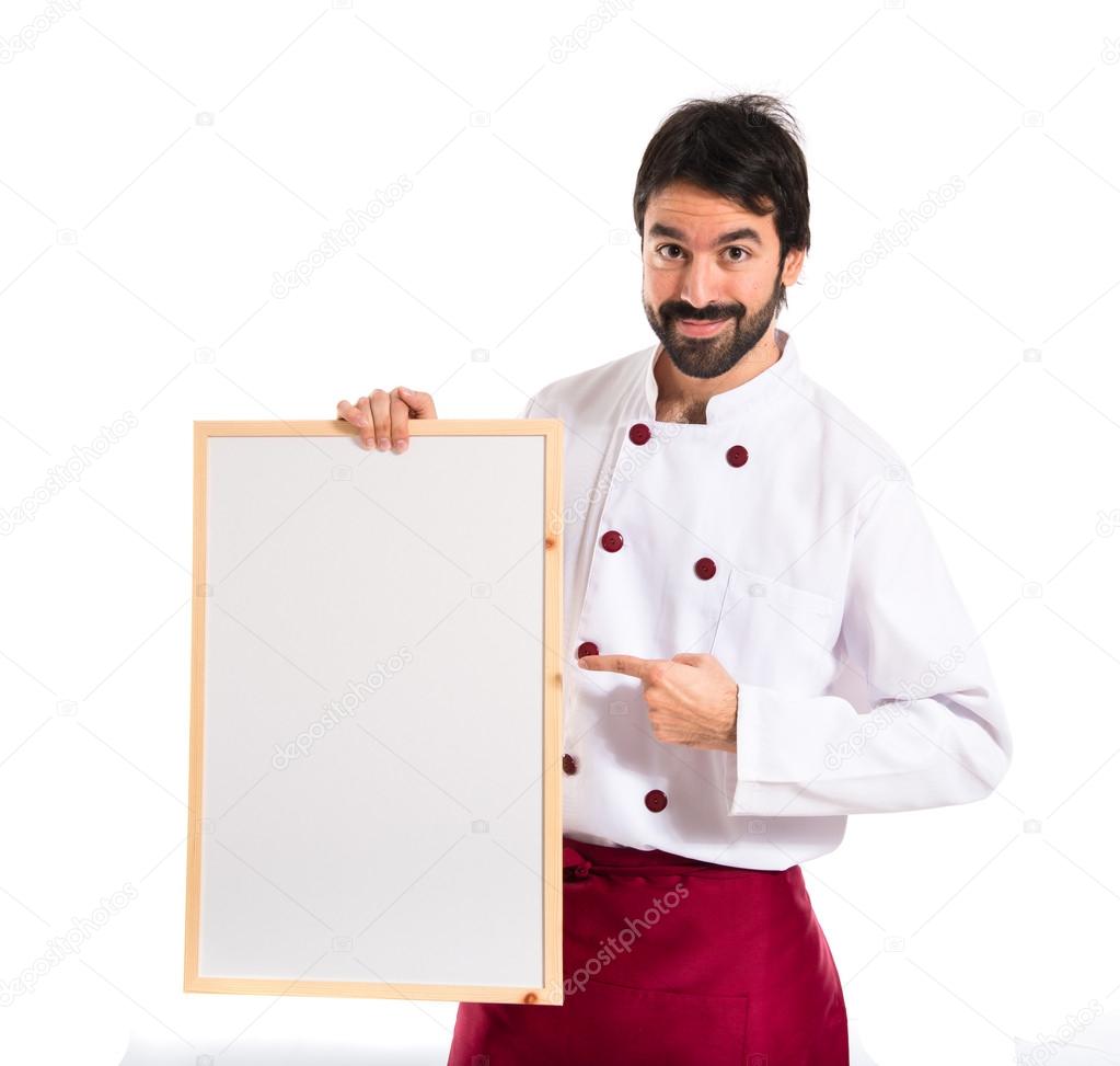 Handsome chef holding empty placard