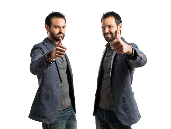 Business man making an OK gesture over isolated white background — стоковое фото