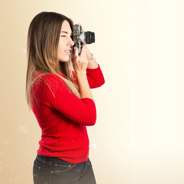 Girl taking a picture over white background — Stock Photo, Image