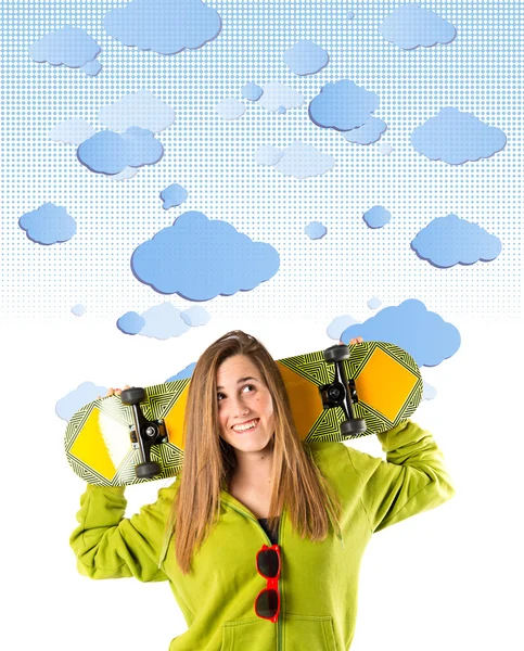 Skater with green sweatshirt over clouds background — Stock Photo, Image