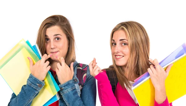 Student women with her fingers crossed over white background — Stock Photo, Image