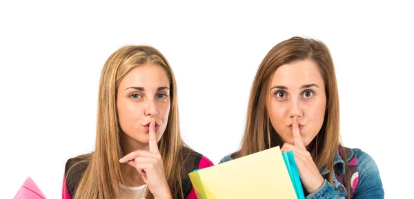 Students making silence gesture over white background — Stock Photo, Image