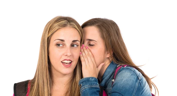 Student women whispering over white background — Stock Photo, Image