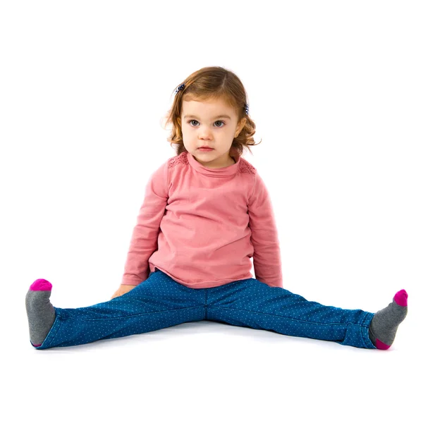 Little girl sitting over white background — Stock Photo, Image