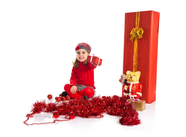 Lille pige omkring juleelementer - Stock-foto