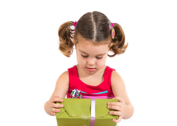 Kid holding a present over white background — Stock Photo, Image