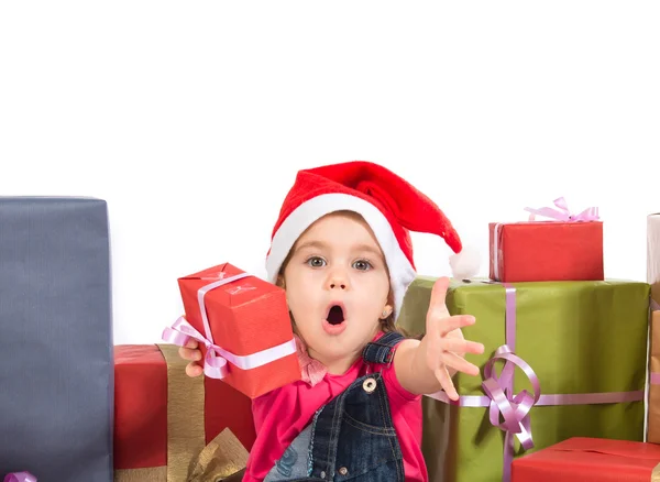 Blonde christmas kid around several presents doing surprise gest — Stock Photo, Image