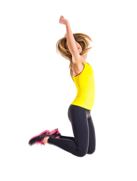 Sportovní žena skákající přes bílé pozadí — Stock fotografie