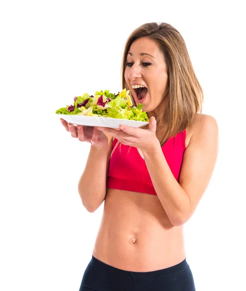 Sportlerin hält Salat in der Hand — Stockfoto