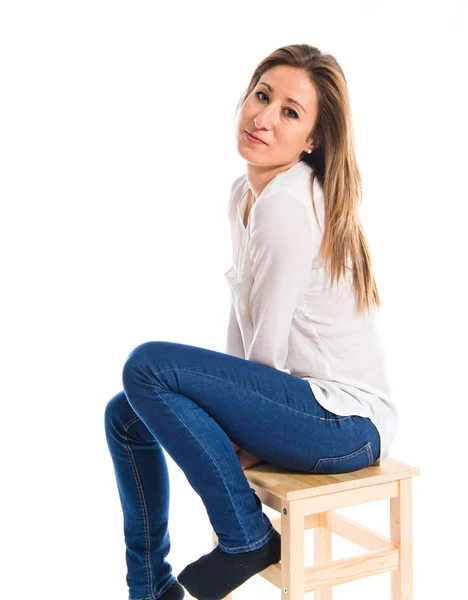 Pretty blonde girl sitting on chair — Stock Photo, Image