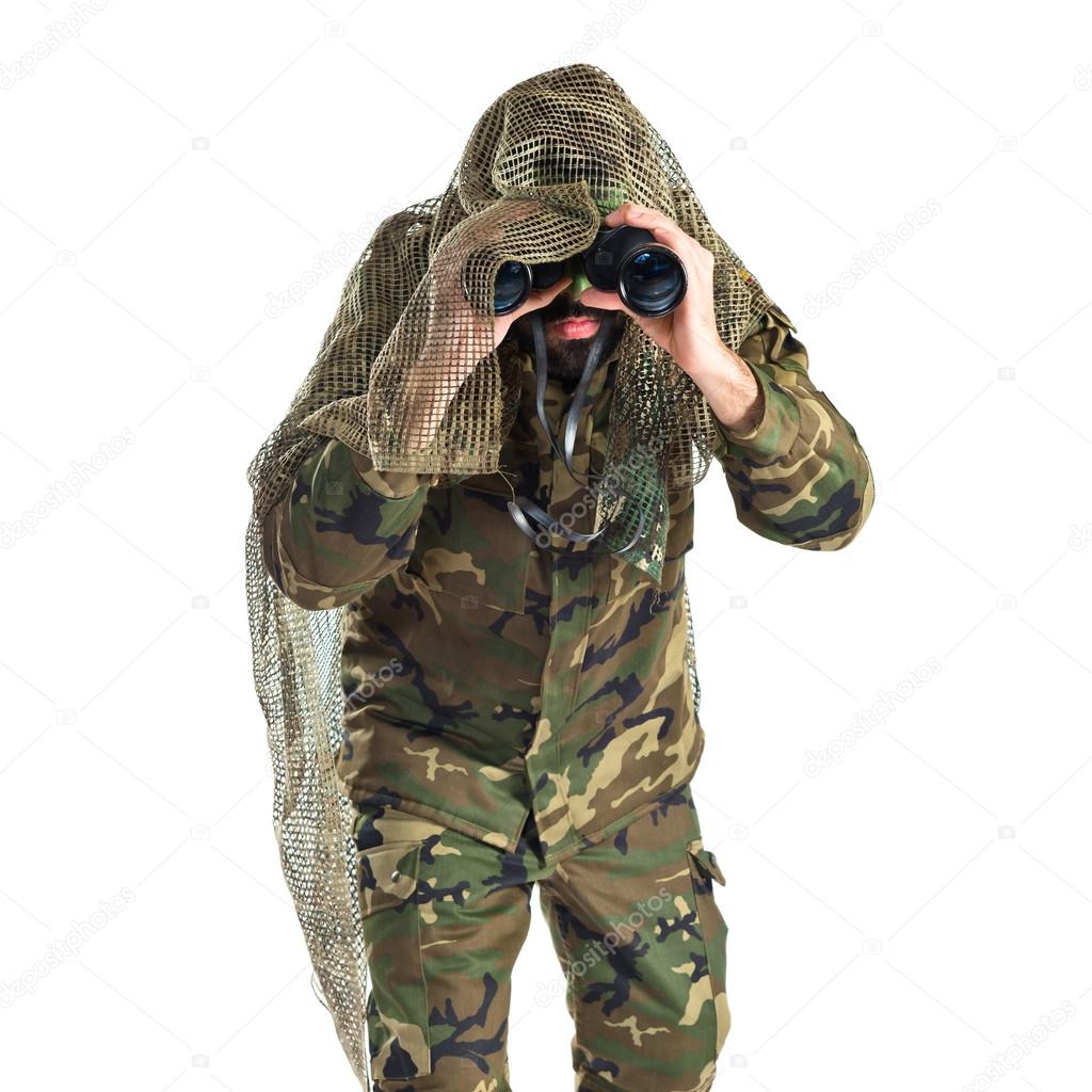 Soldier with binoculars over white background  