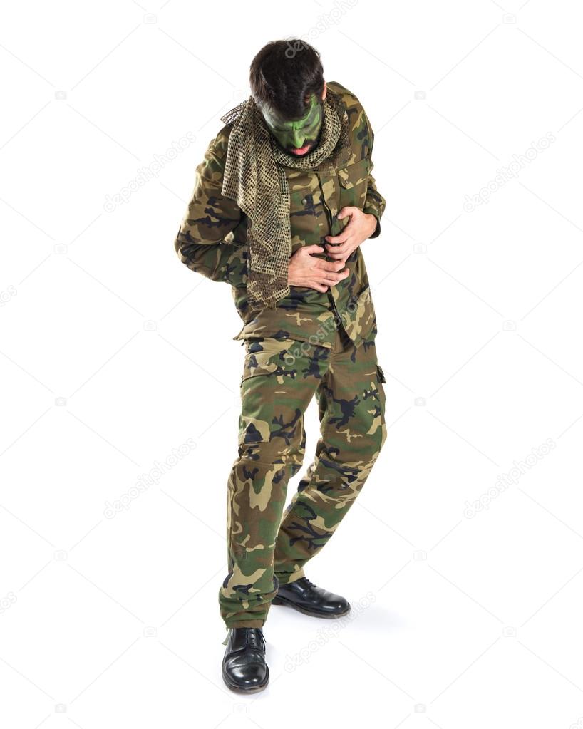 Soldier  with stomachache over white background 