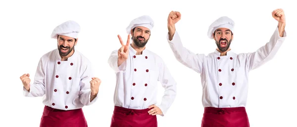 Chef doing victory gesture over white background — Stock Photo, Image