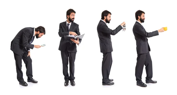 Businessman holding a clock over white background — Stock Photo, Image