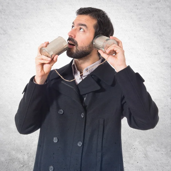 Man talking through a tin phone — Stock Photo, Image