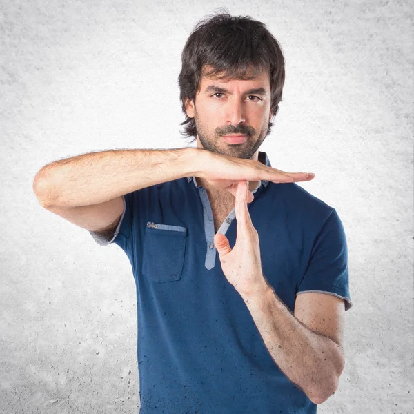 Man making time out gesture over white background — Stock Photo, Image