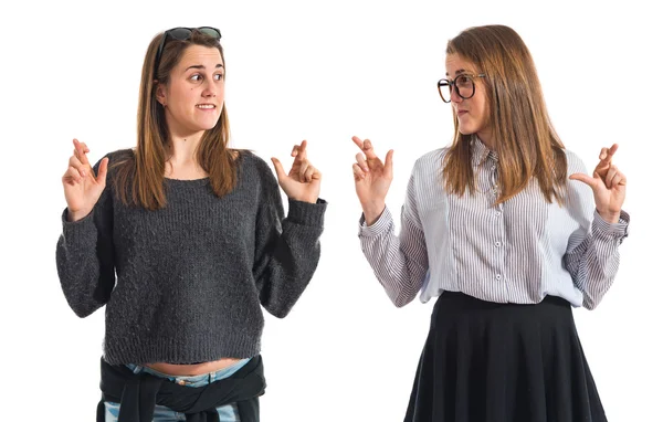 Twin sisters with fingers crossing — Stock Photo, Image