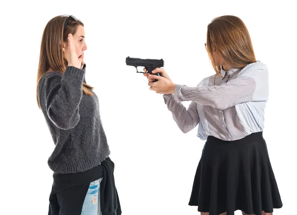 Teen girl pointing with a gun — Stock Photo, Image