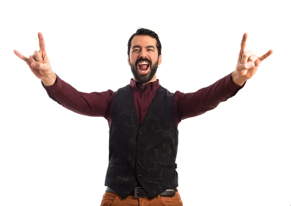 Hombre usando chaleco haciendo gesto de cuerno — Foto de Stock