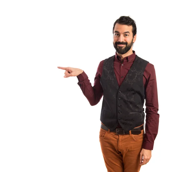 Man wearing waistcoat pointing to the lateral — Stock Photo, Image